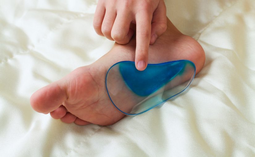 A person is holding a blue foot pad, showcasing its color and design in a clear and focused manner.