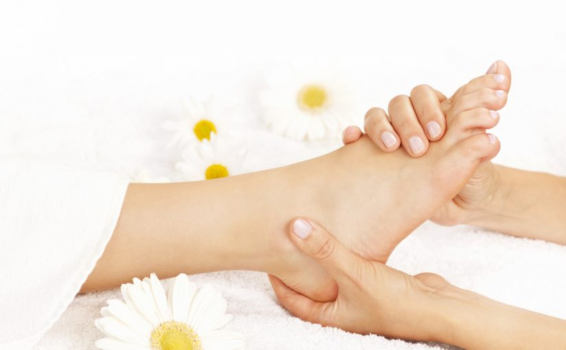 A woman enjoys a relaxing foot massage surrounded by beautiful flowers, creating a serene and tranquil atmosphere.