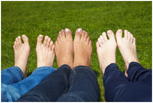 Legs of three persons stock photo